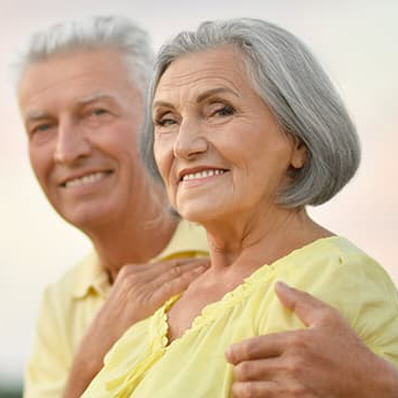 Older couple smiling at camera