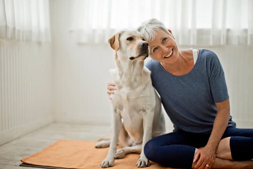 Older Woman sitting on floor with dog