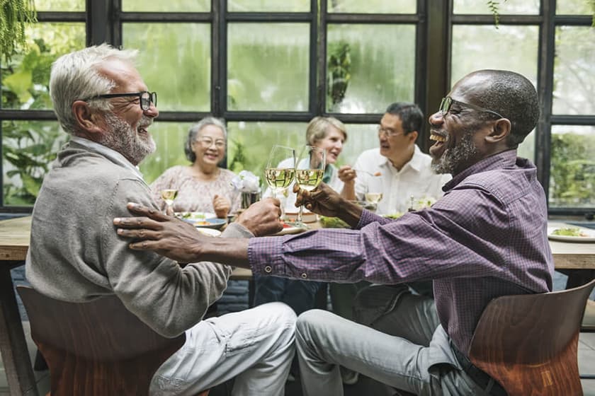 A group of older people drinking one